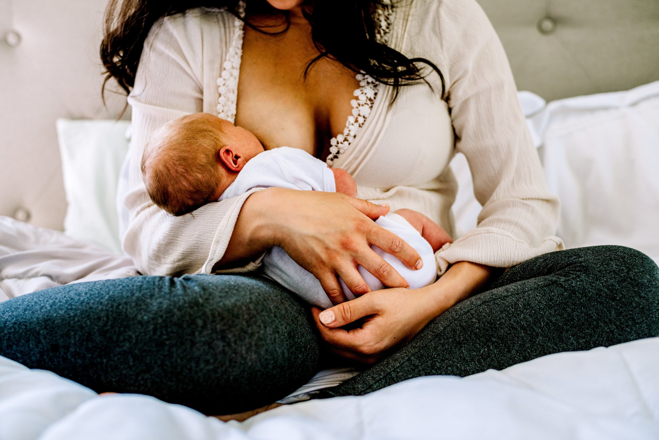 mom breastfeeding a newborn baby girl in Baltimore, Maryland