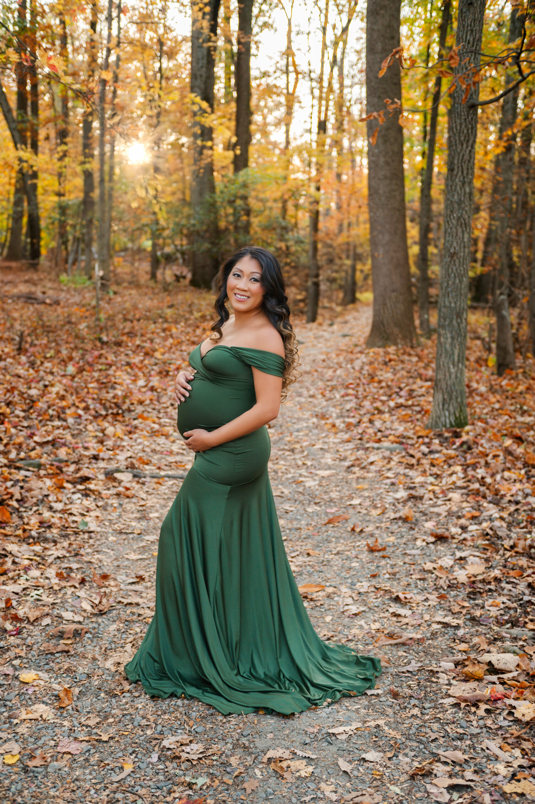 Women in the woods during the fall at Baltimore maternity photography session