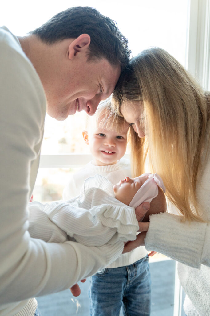 Sibling meeting the new baby during a family newborn photoshoot