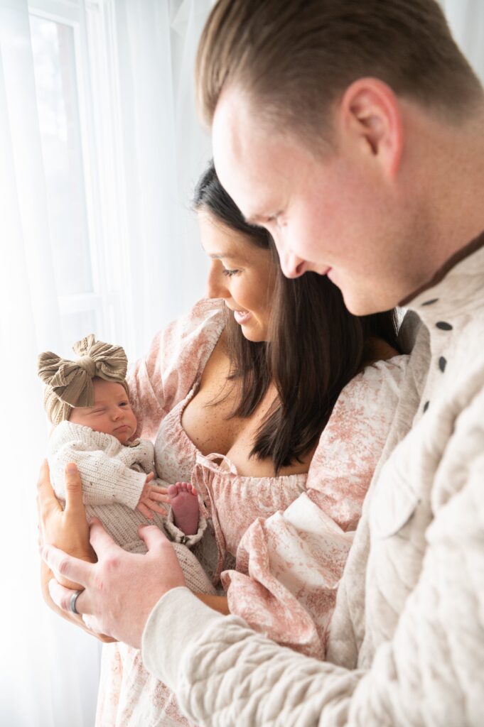 Close-up of baby resting on mother’s shoulder during newborn photography session.