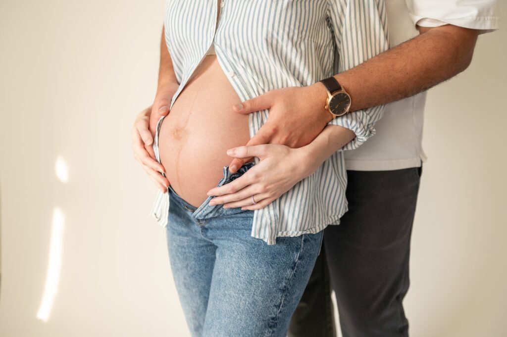 Maternity photoshoot with a woman showing her bump