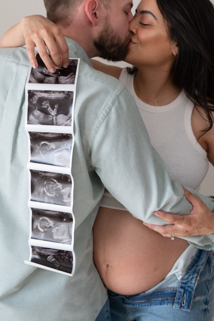 Expecting mother holding her belly during an in studio maternity session in Baltimore.